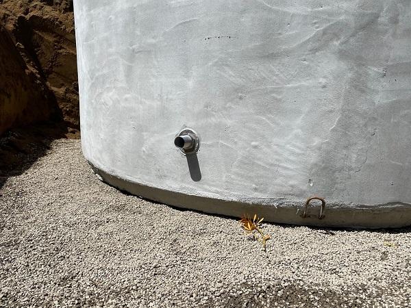 Close-up of the outlet valve on the base of a concrete water tank